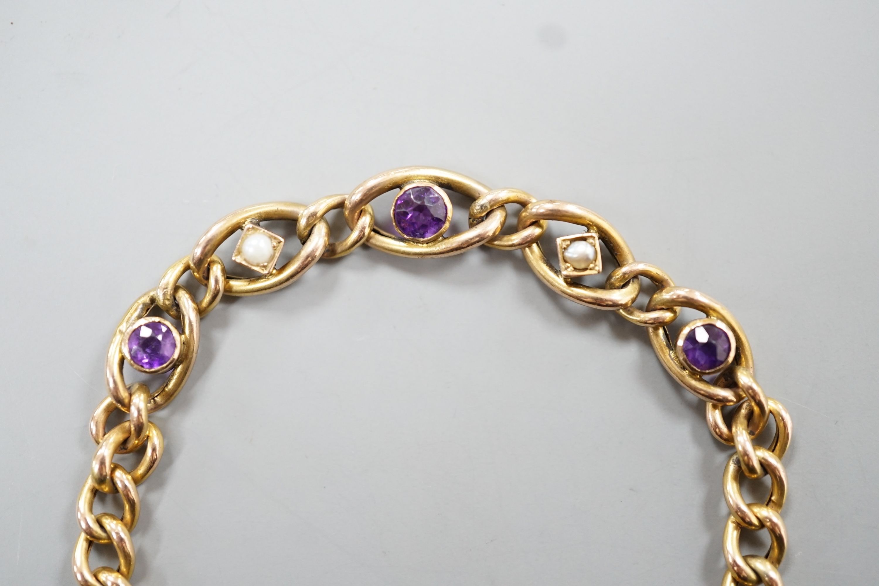 An Edwardian 9ct, amethyst and seed pearl set bracelet, 18cm, 6.1 grams.